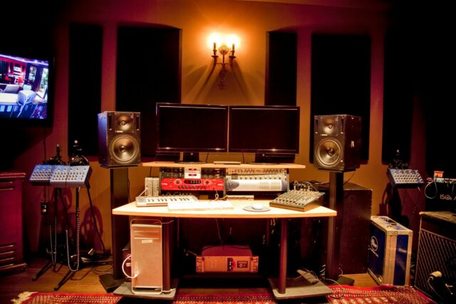 Recording studio mixing station with black acoustic panels on walls